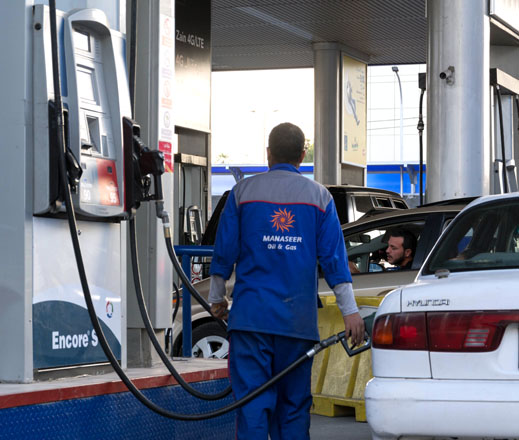 An attendant at a gas station operated by Al Manaseer serves a customer in Amman recently (Photo by Amjad Ghsoun)